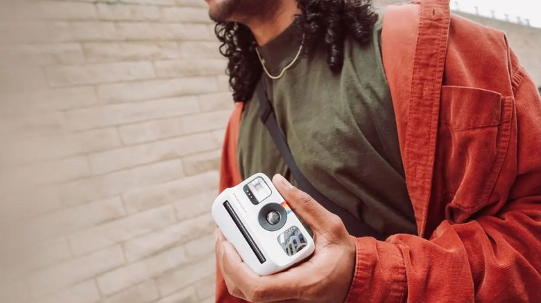 Man holding polaroid camera