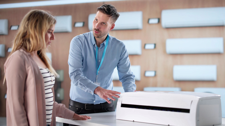 Salesman helping a buyer with AC purchase
