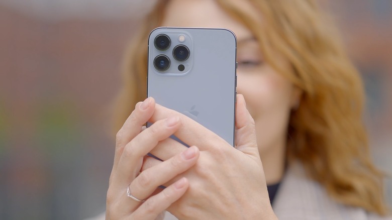 Woman holding iPhone 13 Pro