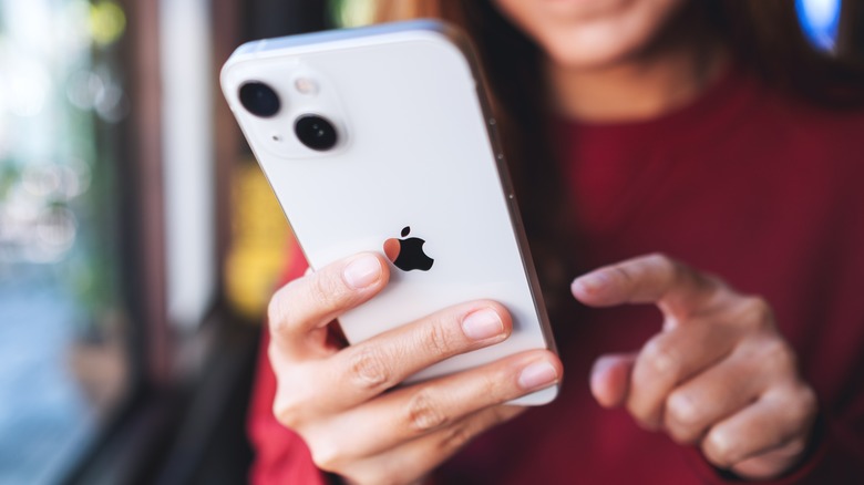 Woman holding iPhone 13