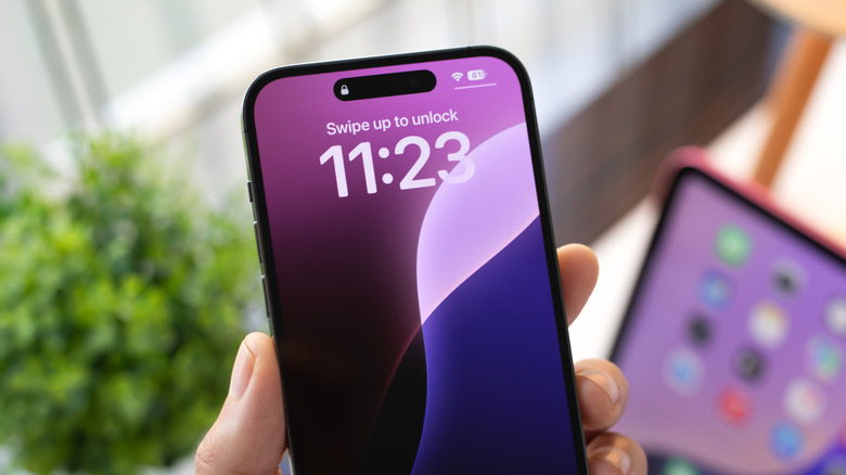 Close up of iPhone in hand showing lock screen