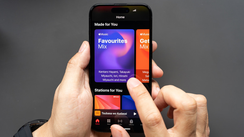 Person using Apple Music on an iPhone
