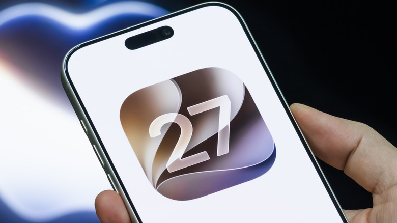 Person holding iPhone with IOS 27 logo on the screen