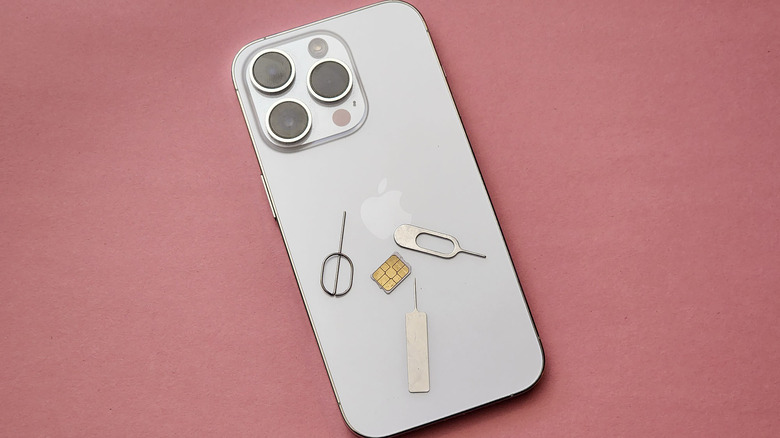 iPhone 14 Pro with SIM card and SIM ejector pins