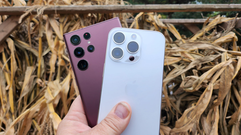 hand holding two phones