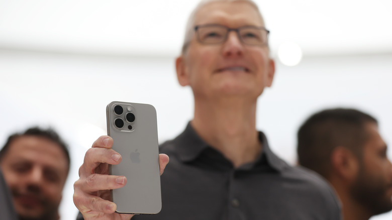 Tim Cook with the iPhone 15 Pro in his hands.