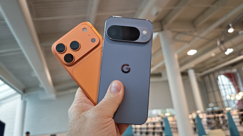 A man holding a Pixel 10 Pro and iPhone 17 Pro