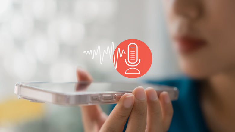 woman holding iPhone speaking to mic