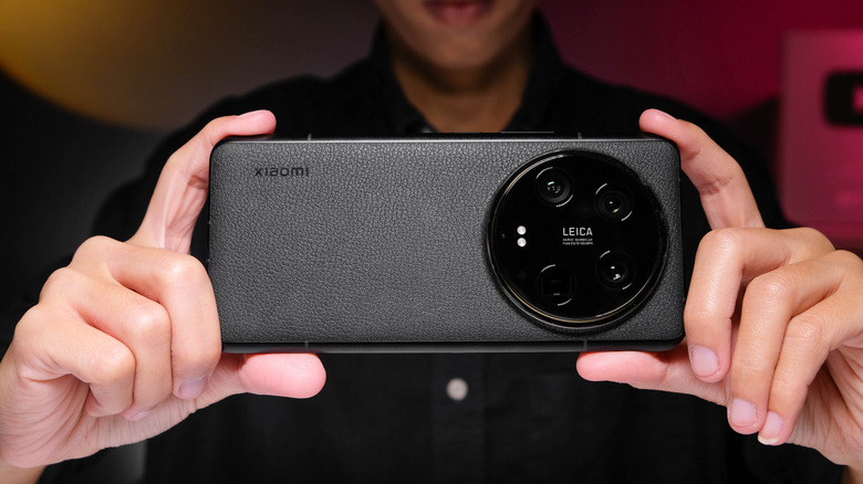 A person clicking a photo using a Xiaomi 14 Ultra smartphone