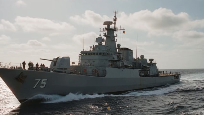 Crewmembers stand abord IRIS Dena at sea.