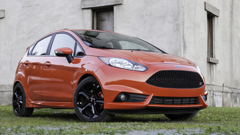 A red 2016 Ford Fiesta ST in front of a building
