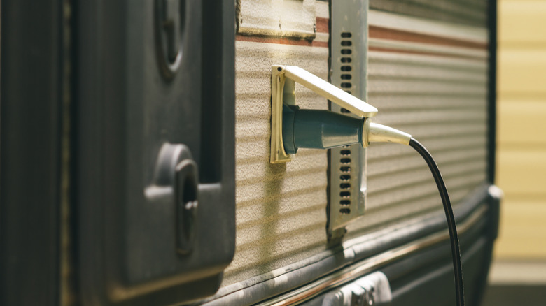An image showing a close up of a power cord plugged into an RV/camper