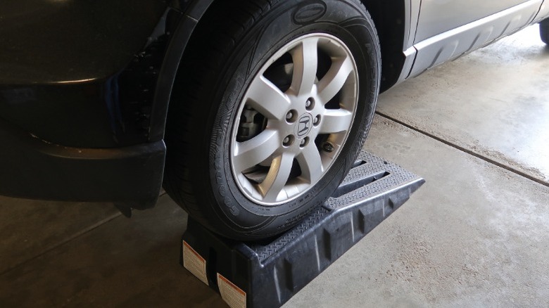 A Honda parked on a set of automotive ramps