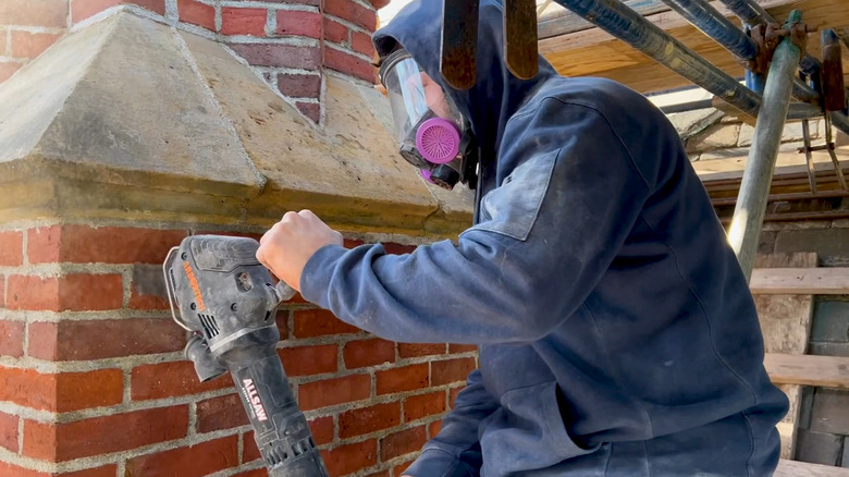 Man using an Arbotech Allsaw on an exterior brick chimney