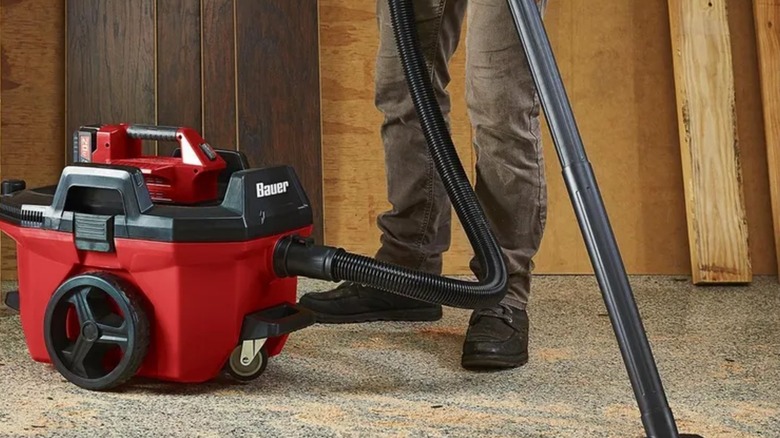 person using Bauer wet and dry vacuum