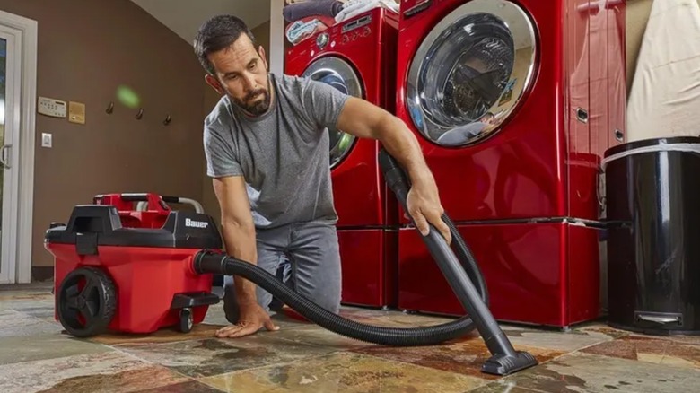 man cleaning floor with Bauer vacuum