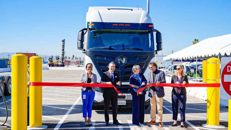 Officials cut the ribbon at electric-truck charging ports at the Long Beach port in 2022.