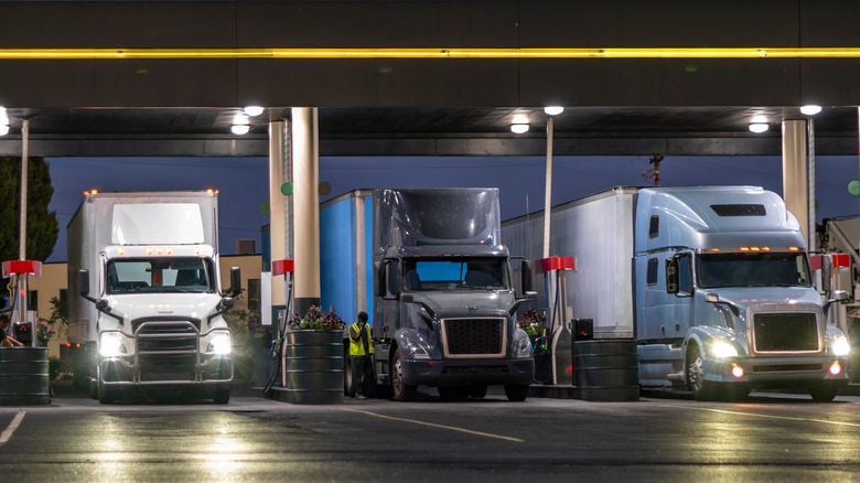 Industrial diesel trucks fill up the tank