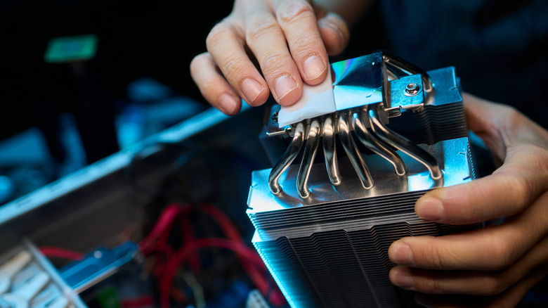 PC builder peeling plastic off of contact point of an air CPU cooler