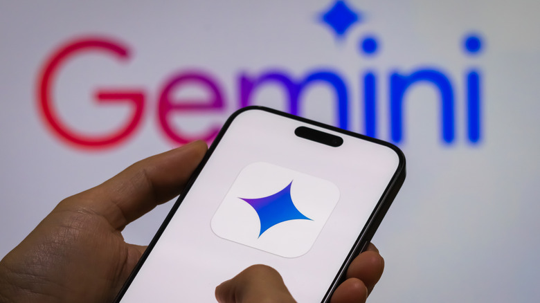 Phone showing Gemini logo onscreen with Gemini banner in background