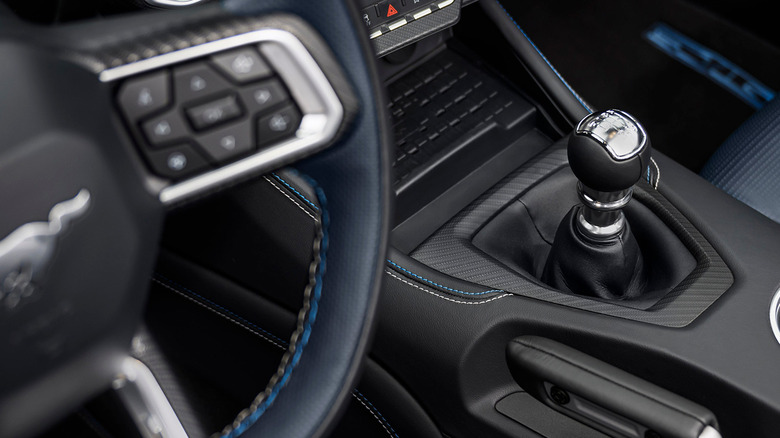 Interior view of steering wheel and manual shifter on Ford Mustang GT.