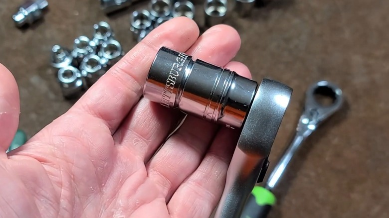 A person holding a Pittsburgh socket wrench.