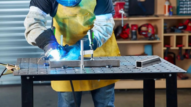 a person using the harbor freight titanium welding table