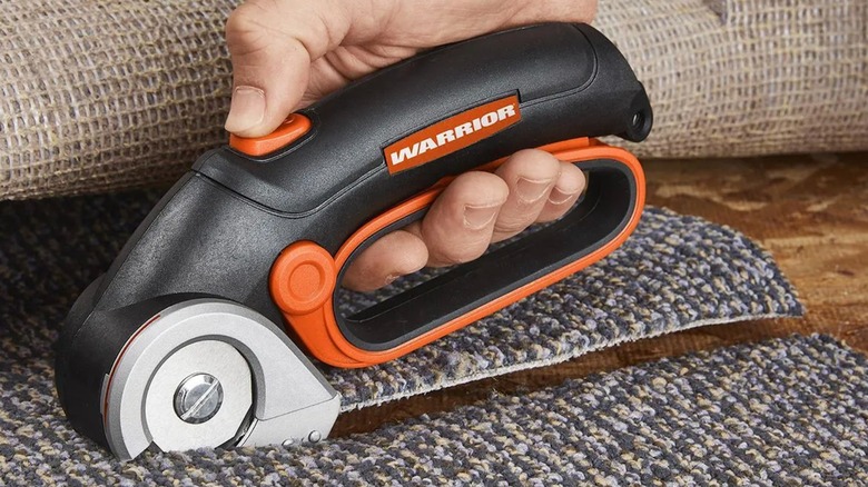 Warrior 4V Cordless Power Cutter cutting carpet