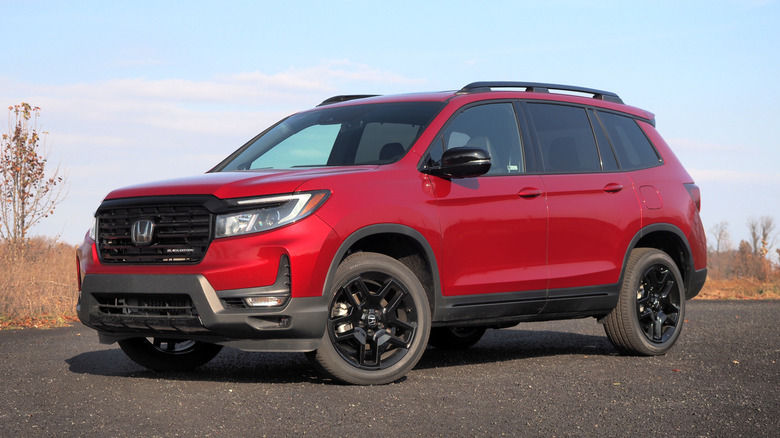 Red 2024 Honda Passport parked on a rural road