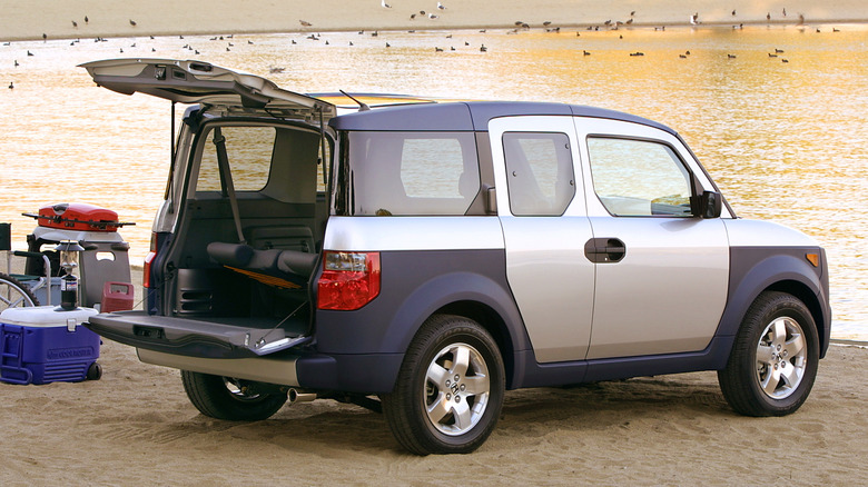 Rear 3/4 view of a silver Honda Element with the split-tailgate open