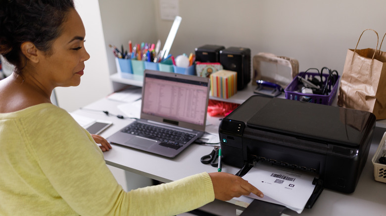 Person printing documents at desk