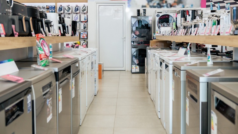 Retail aisle featuring multiple dishwasher models