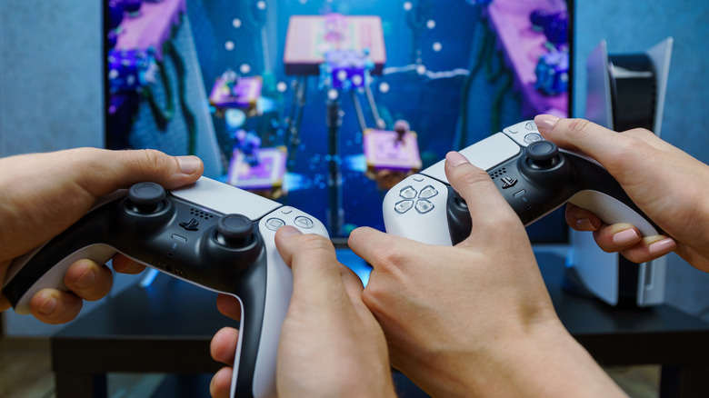 Two people using PlayStation 5