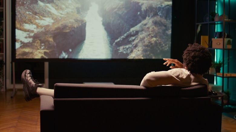 man watching projector