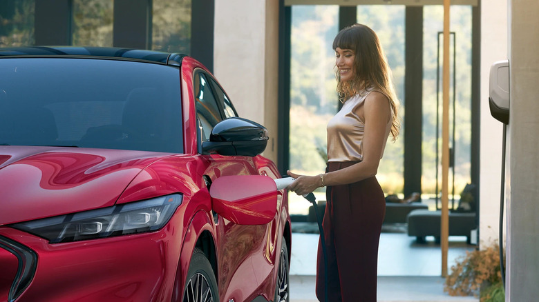 woman putting charger in 2025 Ford Mustang Mach-E