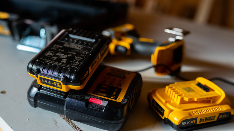 DeWalt battery charging with a drill in the background