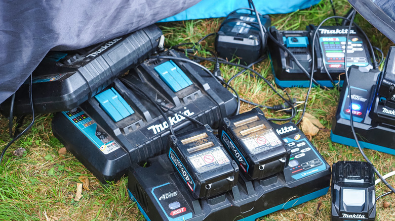 Makita batteries and chargers on the ground