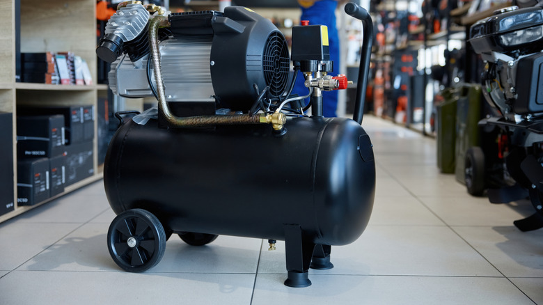 An image of a portable air compressor placed on the floor