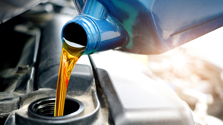 Oil being poured into car engine
