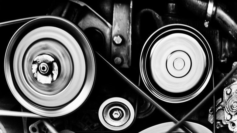 Serpentine belt and pulleys on front of car engine