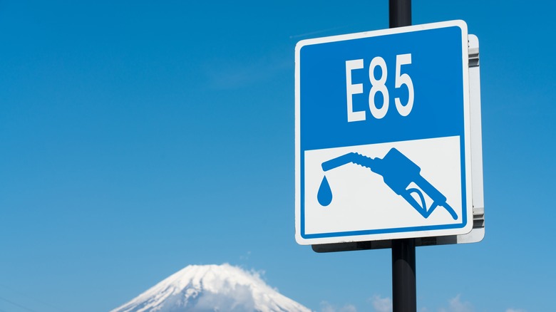 A blue E85 road sign with Mount Fuji in the background