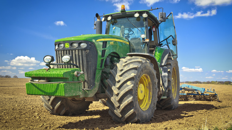 A heavy John Deere farm tractor in a field.