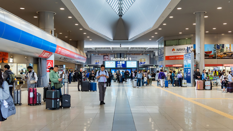 Interior of the main hall of Kansai International Airport Terminal 1 with passengers and commuters