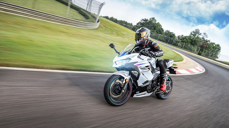 person riding Kawasaki Ninja 400 on track