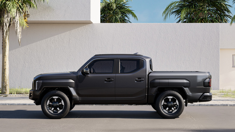Driver side view of Kia Tasman pickup truck parked on street
