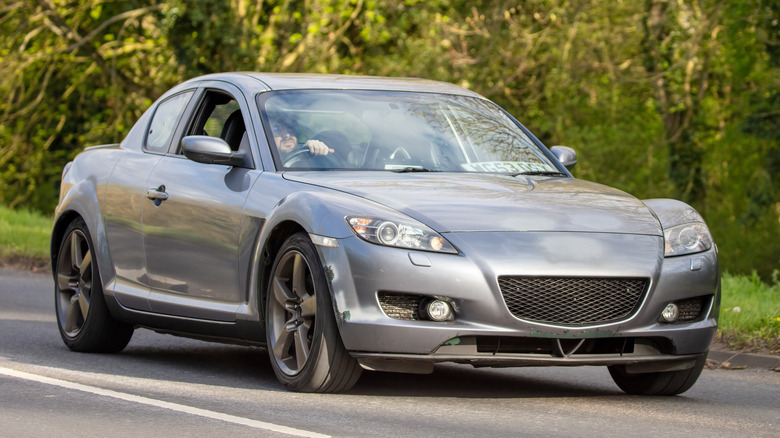A Mazda RX-8 being driven along a road.