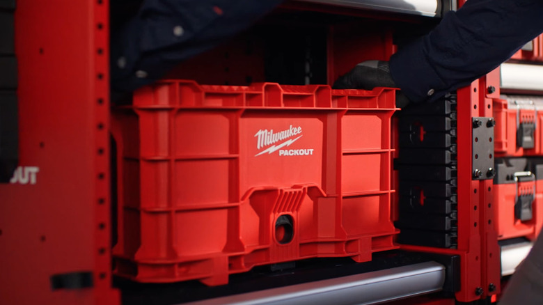 Person gripping Milwaukee Packout container