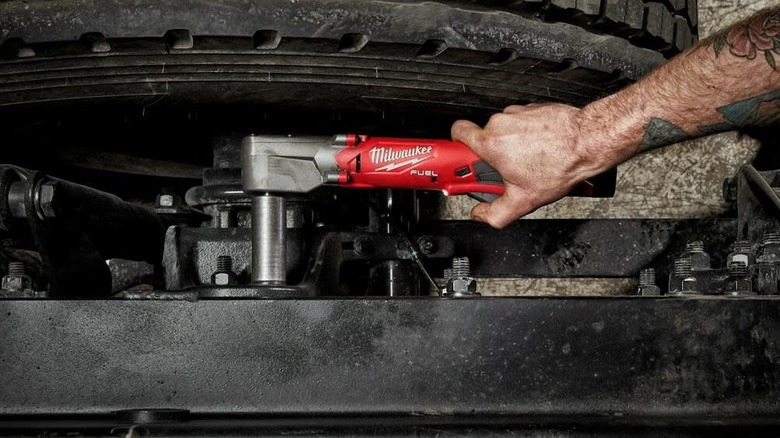 Milwaukee M12 FUEL 1/2inch Right Angle Impact Wrench being used on car