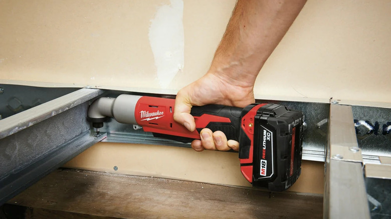 Milwaukee M18 1/4-Inch Right Angle Impact Driver being used on metal beam