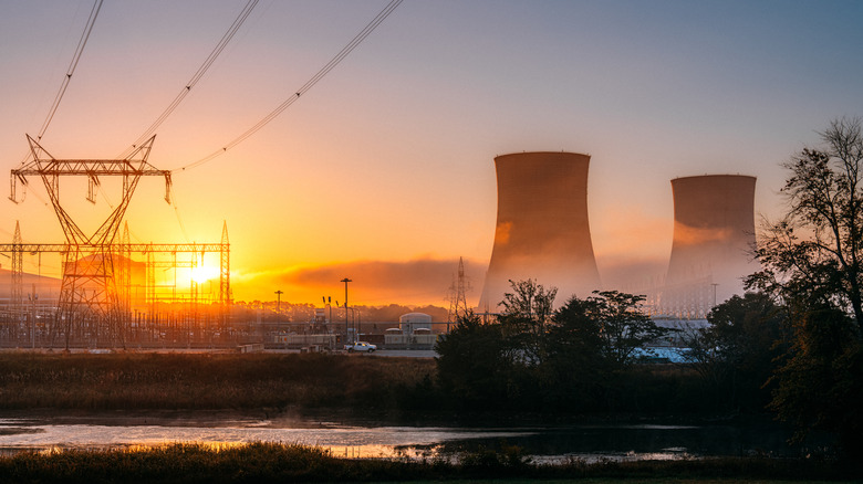 Two cooling towers of a nuclear power facility stand out against a Tennessee landscape.